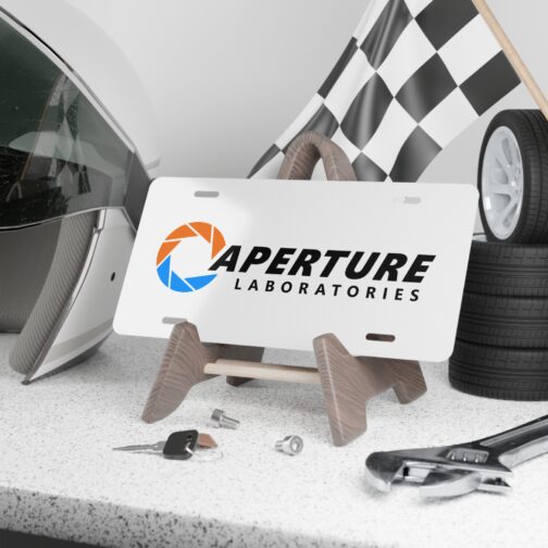 aperture-laboratories-decorative-vanity-license-plate-white-background-display-mockup Aperture Laboratories novelty license plate white background shown as a display piece, science laboratory vanity car tag. Inspired by Portal.