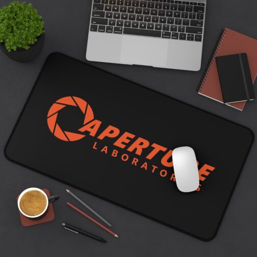 Aperture Laboratories orange logo black desk mat - angled desk view with a mouse Black Portal desk mat with a large orange Aperture Laboratories logo, angled desk view with a mouse