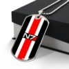 Silver-tone N7 dog tag from Mass Effect, angled front resting against a box