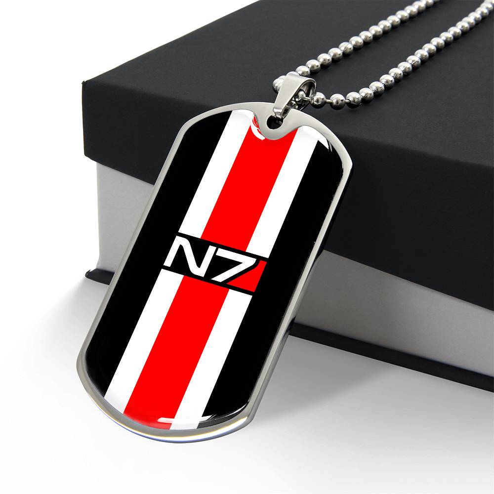 Silver-tone N7 dog tag from Mass Effect, angled front resting against a box